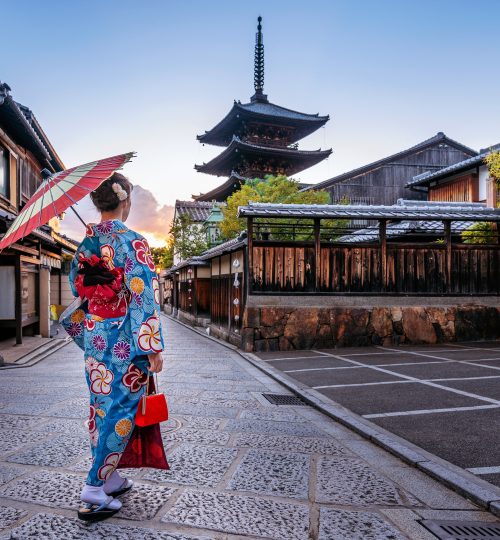 woman wearing japanese traditional kimono with umbrella at Yasaka Pagoda and Sannen Zaka Street in Kyoto, Japan.